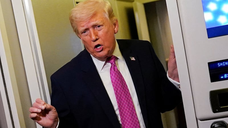 U.S. President Donald Trump talks to members of the media aboard Air Force One en route to Joint Base Andrews, Maryland, U.S., March 29, 2026.