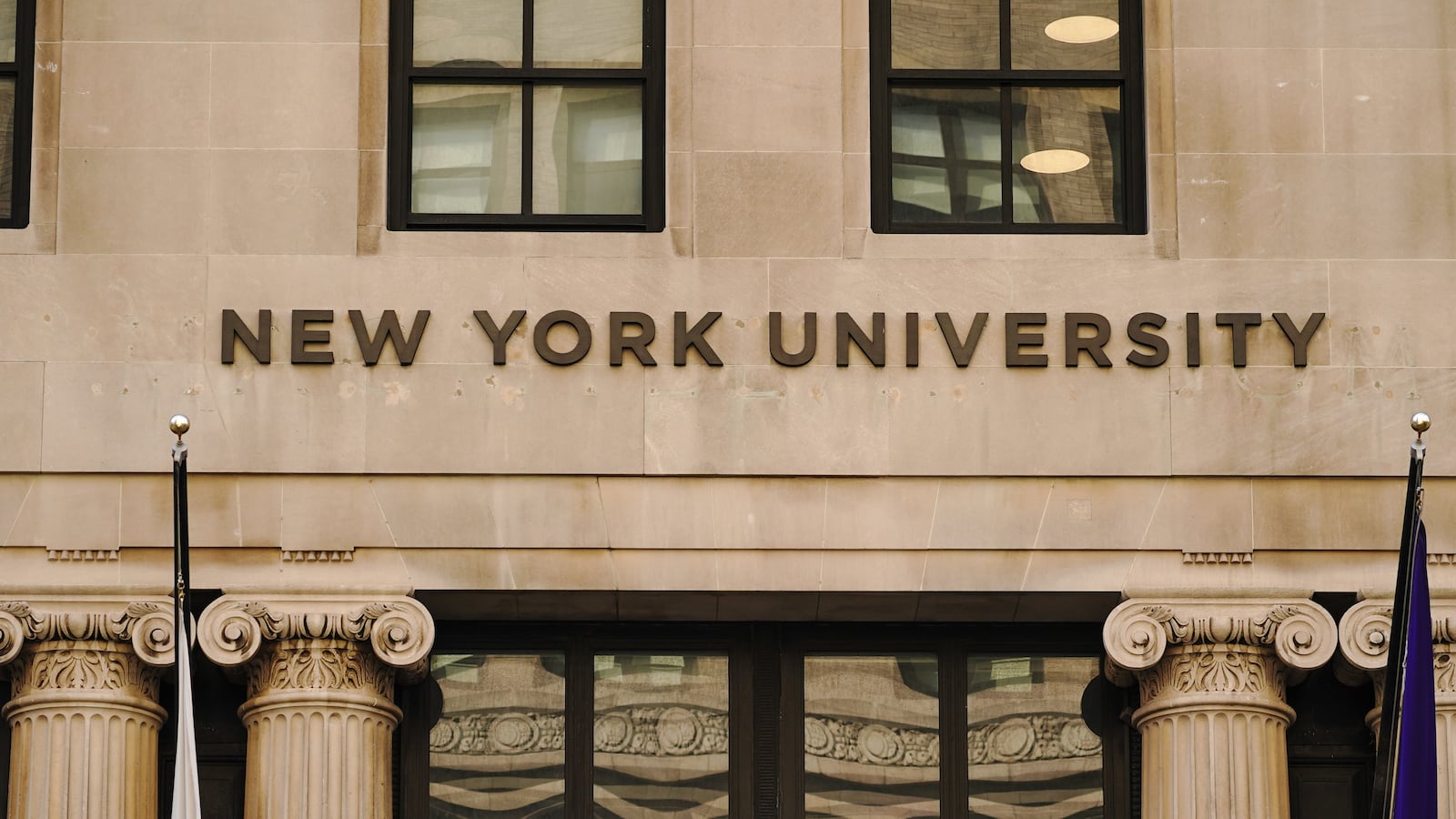 A view of a New York University sign on the campus building. Stuart Robinson, the director of athletics at New York University, has been placed on administrative leave after allegations of sexual abuse and harassment.