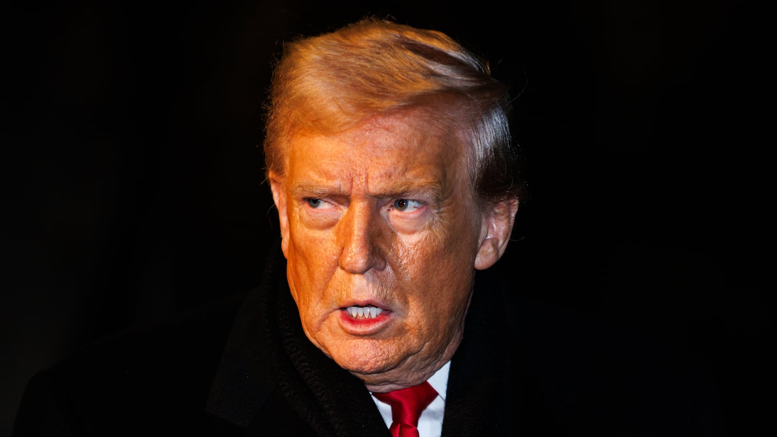 President Donald Trump walks over to reporters to make a brief statement before departing from the South Lawn of the White House in Marine One on January 20, 2026 in Washington, DC.