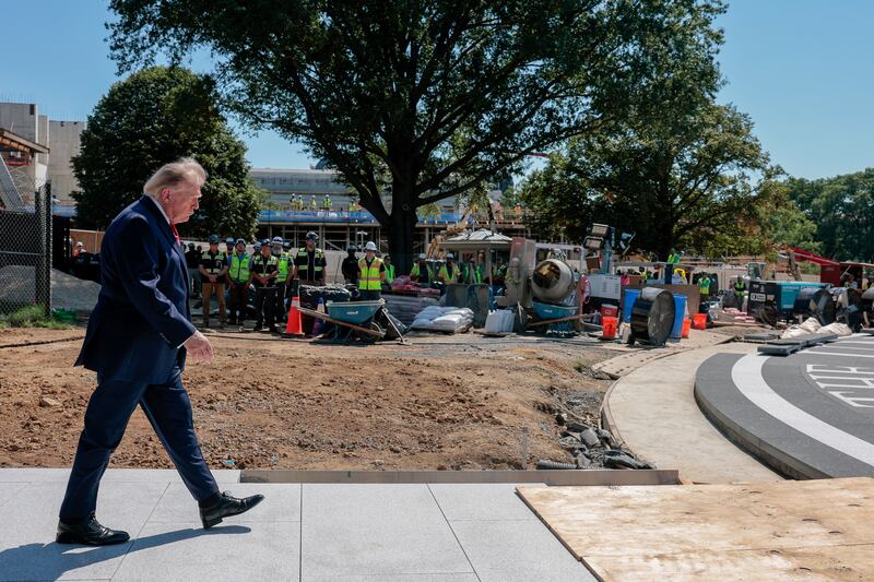 Trump walks out to the site of the helipad being constructed on the South Lawn.