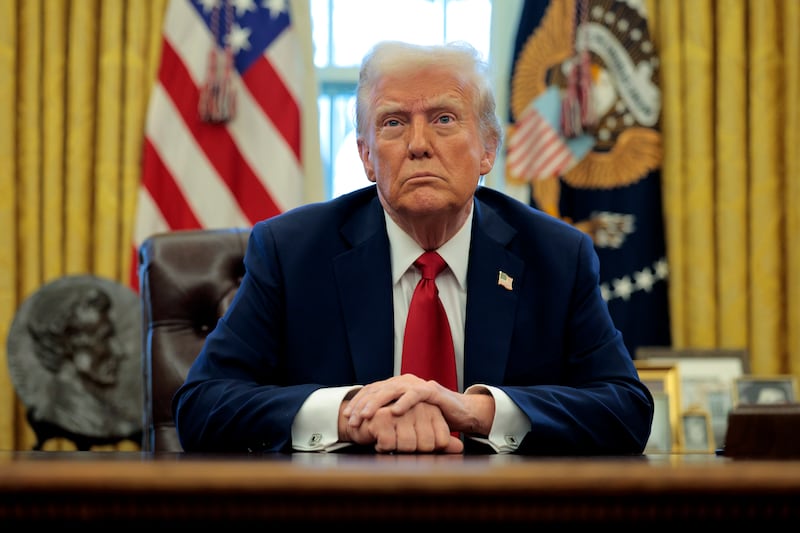 President Donald Trump talks to reporters from the Resolute Desk in the Oval Office at the White House on January 30, 2025 in Washington, DC.