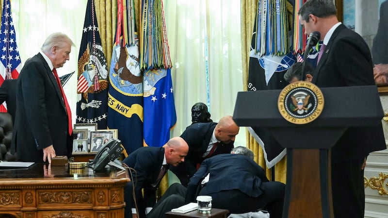 President Donald Trump looks on after a man fainted during an announcement about weight-loss drugs in the Oval Office of the White House in Washington, DC on November 6, 2025.