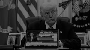 US President Donald Trump plays a CNBC news clip on a laptop