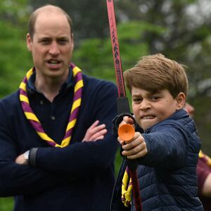 Britain's Prince George of Wales tries his hand at archery as Britain's Prince William, Prince of Wales, watches him, while taking part in the Big Help Out, during a visit to the 3rd Upton Scouts Hut in Slough, west of London, Britain, May 8, 2023.