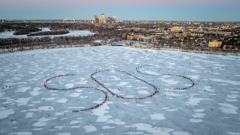 In an aerial view, demonstrators spell out an SOS signal of distress on a frozen lake