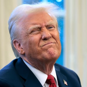 President Donald Trump reacts to a reporter's question from the Resolute Desk after signing an executive order to appoint the deputy administrator of the Federal Aviation Administration in the Oval Office at the White House on January 30, 2025 in Washington, D.C.
