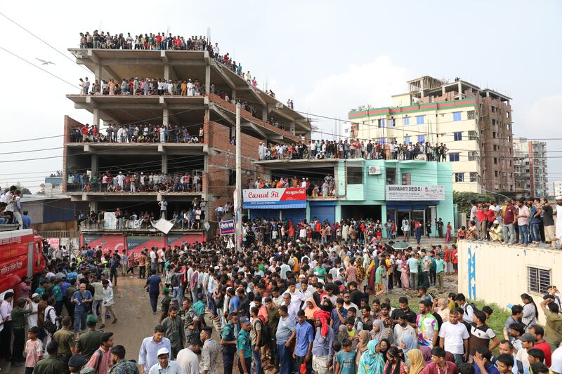 A large crowd gathers after a Bangladesh Air Force F7 aircraft crashed into a building of Milestone College in  Dhaka, Bangladesh.