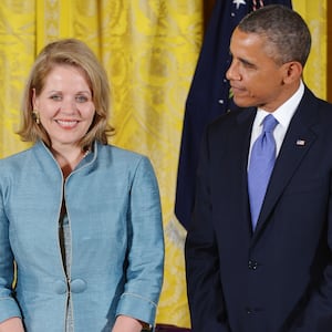 Then U.S. President Barack Obama smiles while standing with 2012 National Medal of Arts recipient soprano Renée Fleming.
