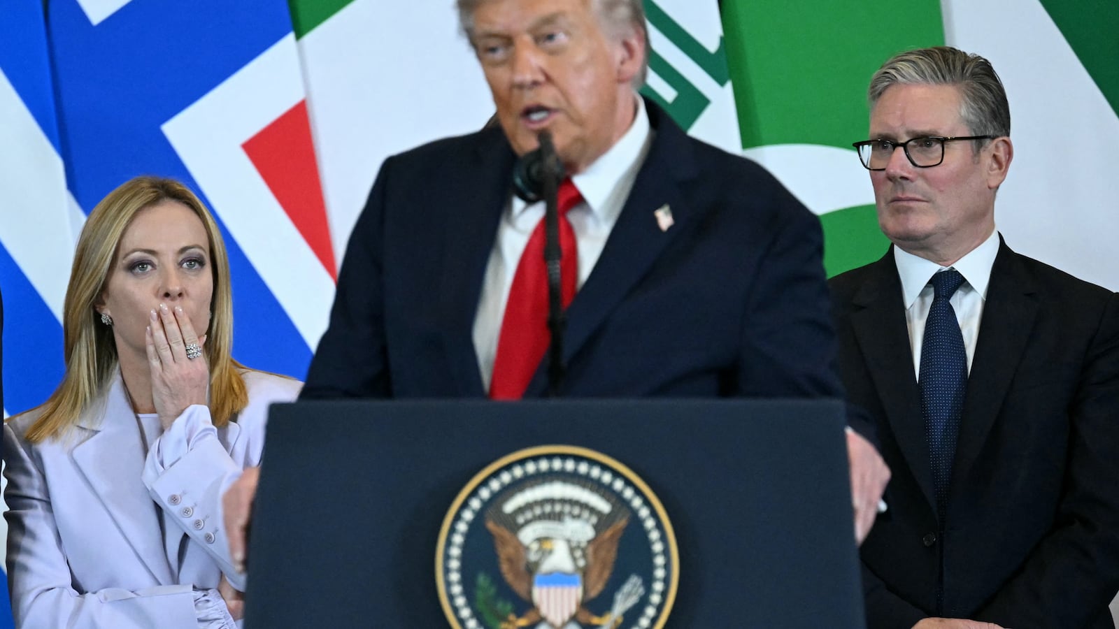US President Donald Trump (C) speaks as Italian Prime Minister Giorgia Meloni (L) and Britain's Prime Minister Keir Starmer watch during the Sharm El-Sheikh Peace Summit in the Egyptian Red Sea resort town of Sharm el-Sheikh on October 13, 2025. Trump on October 13 hailed a Gaza summit in Egypt as a "tremendous day" for the Middle East, saying a document would be signed on "rules and regulations" for future talks. (Photo by SAUL LOEB / AFP) (Photo by SAUL LOEB/AFP via Getty Images)