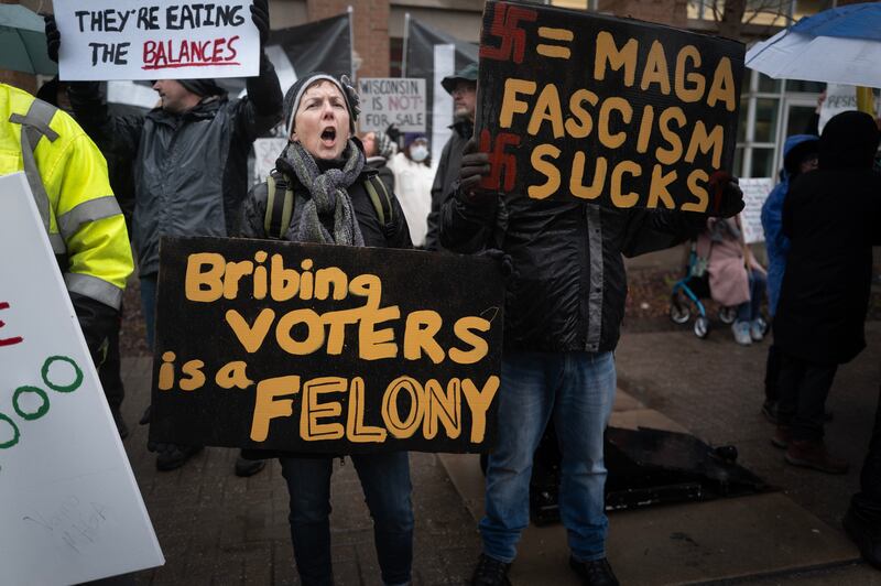GREEN BAY, WISCONSIN - MARCH 30: Demonstrators protest outside the KI Convention Center before the start of a town hall meeting with Elon Musk on March 30, 2025 in Green Bay, Wisconsin. The town hall is being held in front of the state’s high-profile Supreme Court election between Circuit Court Judge Brad Schimel, who has been financially backed by Musk and endorsed by President Donald Trump, and Dane County Circuit Court Judge Susan Crawford. (Photo by Scott Olson/Getty Images)