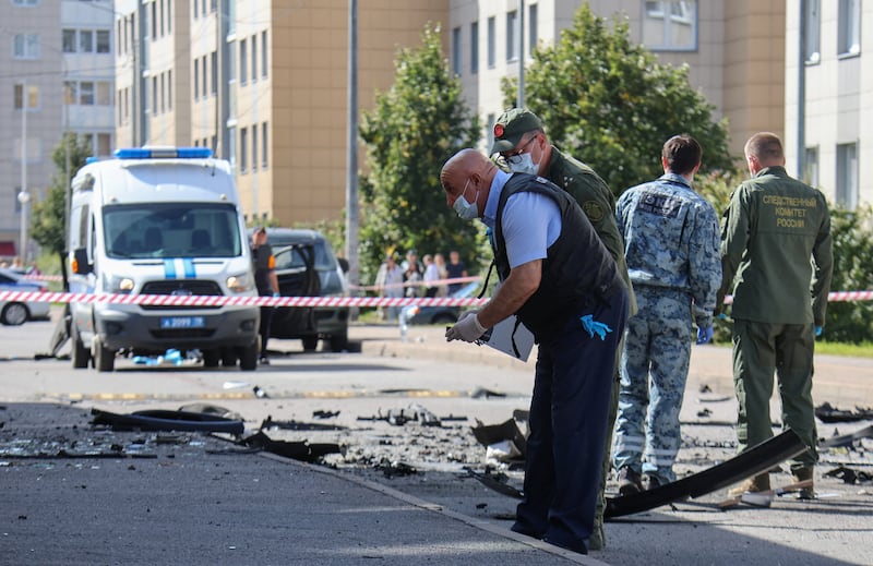 Investigators work on the site of a car explosion, which killed a Russian military serviceman, in Saint Petersburg, Russia August 27, 2026.