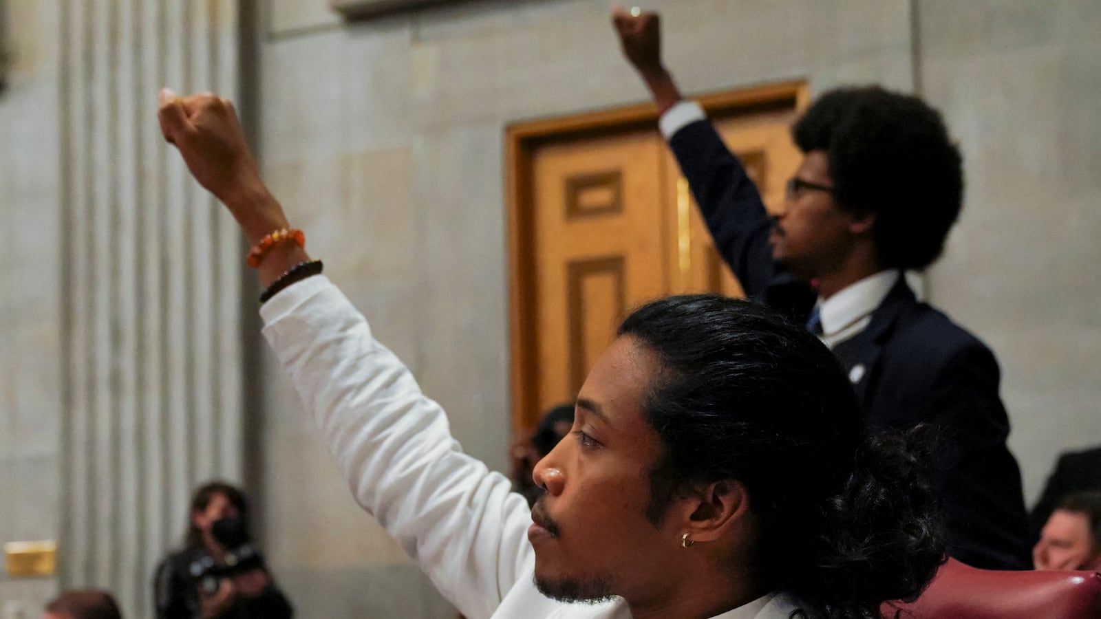 Rep. Justin Pearson and Rep. Justin Jones raise their fists