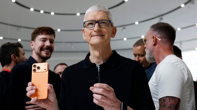 CUPERTINO, CALIFORNIA - SEPTEMBER 09: Apple CEO Tim Cook holds a next generation iPhone 17 during an Apple special event at Apple headquarters on September 09, 2025 in Cupertino, California. Apple unveiled a new generation of iPhones and updated Apple Watches and AirPods during a special event at Apple headquarters.