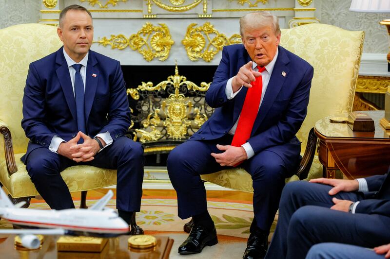 U.S. President Donald Trump points a finger while sitting next to the President of Poland Karol Nawrocki during a meeting in the Oval Office at the White House in Washington, D.C., U.S., September 3, 2025.  REUTERS/Brian Snyder