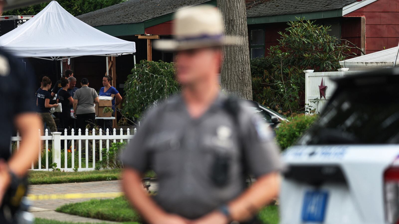 Crime scene investigators are pictured at the residence of architect Rex A. Heuermann