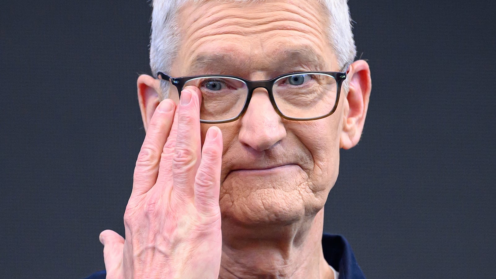 Tim Cook wiping a tear off his face.