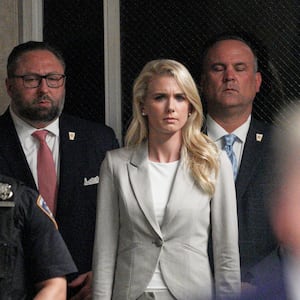 Natalie Harp listens as former U.S. President Donald Trump speaks outside of  Manhattan Criminal Court on April 30, 2024 in New York City.