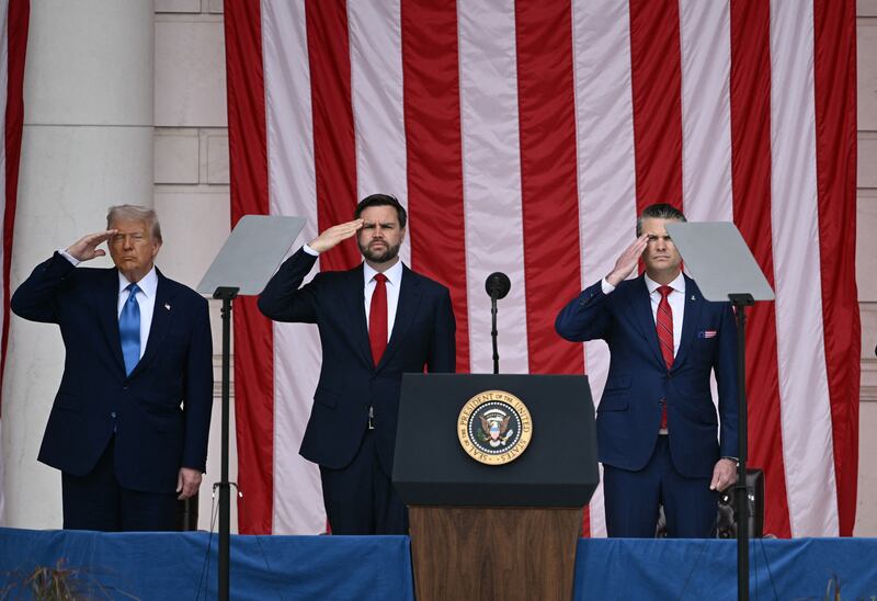 President Donald Trump, US Vice President JD Vance, and US Secretary of Defense Pete Hegseth salute in the amphitheatre at the Tomb of the Unknown Soldier in Arlington National Cemetery in Arlington, Virginia, on Memorial Day, May 26, 2025.