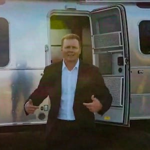 Spencer Pratt emerging from a trailer.