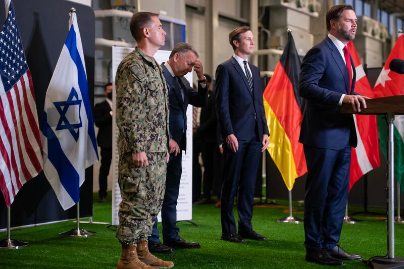 US special envoy Steve Witkof (2nd-L) reacts and Jared Kushner (C) looks on as US Vice President JD Vance speaks during a press conference following a military briefing at the Civilian Military Coordination Center in southern Israel on October 21, 2025. Vance is expected to meet top US Middle East envoys and military experts monitoring the fragile US-brokered ceasefire in Gaza. According to Israeli media reports, he will also meet Israeli leaders, including the Israeli prime minister on October 22 in Jerusalem. (Photo by Nathan HOWARD / POOL / AFP) (Photo by NATHAN HOWARD/POOL/AFP via Getty Images)
