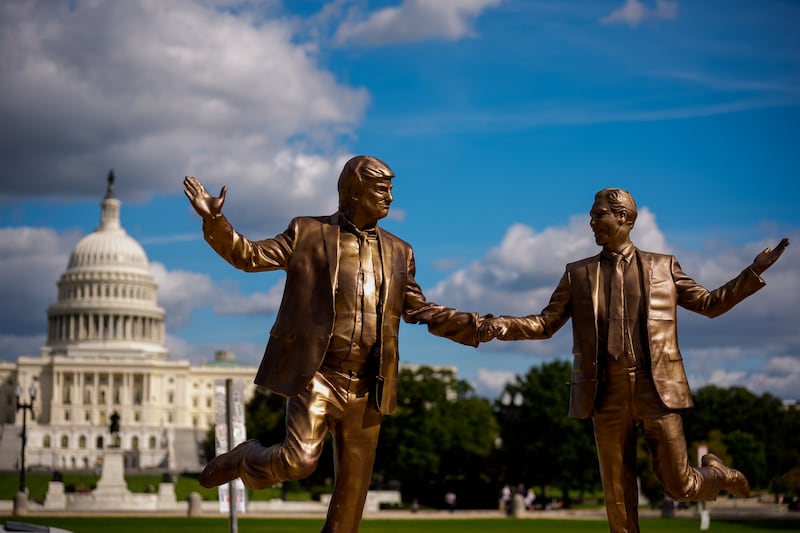 WASHINGTON, DC - OCTOBER 2: The Dome of the U.S. Capitol Building is visible behind a statue depicting U.S. President Donald Trump and Jeffrey Epstein holding hands on the National Mall on October 2, 2025 in Washington, DC. The bronze-painted statue titled "Best Friends Forever" has returned after being taken down by the National Park Service last week due to permit violations. (Photo by Andrew Harnik/Getty Images)