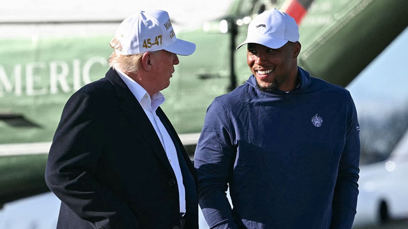 President Donald Trump walks with Philadelphia Eagles running back Saquon Barkley before boarding Air Force One.