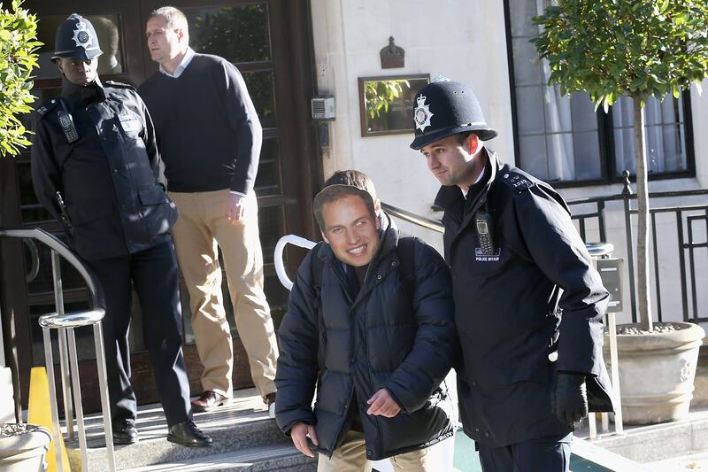 articles/2012/12/04/william-arrives-at-hospital-as-masked-prankster-is-lead-away/will-mask2_hbshm1