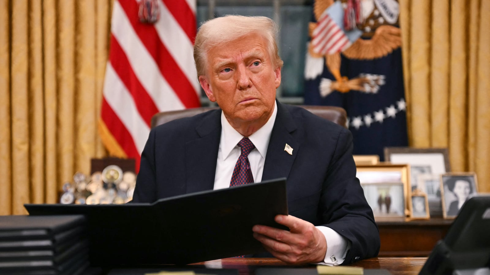 US President Donald Trump signs an executive order for pardons on January 6 offenders in the Oval Office of the WHite House in Washington, DC, on January 20, 2025.