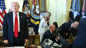 President Donald Trump looks on after a man fainted during an announcement about weight-loss drugs in the Oval Office of the White House in Washington, DC on November 6, 2025. Trump announced deals Thursday with pharmaceutical giants Eli Lilly and Novo Nordisk to lower the prices of some popular weight-loss drugs. Both companies "have agreed to offer their most popular GLP-1 weight-loss drug," Trump said, "at drastic discounts."