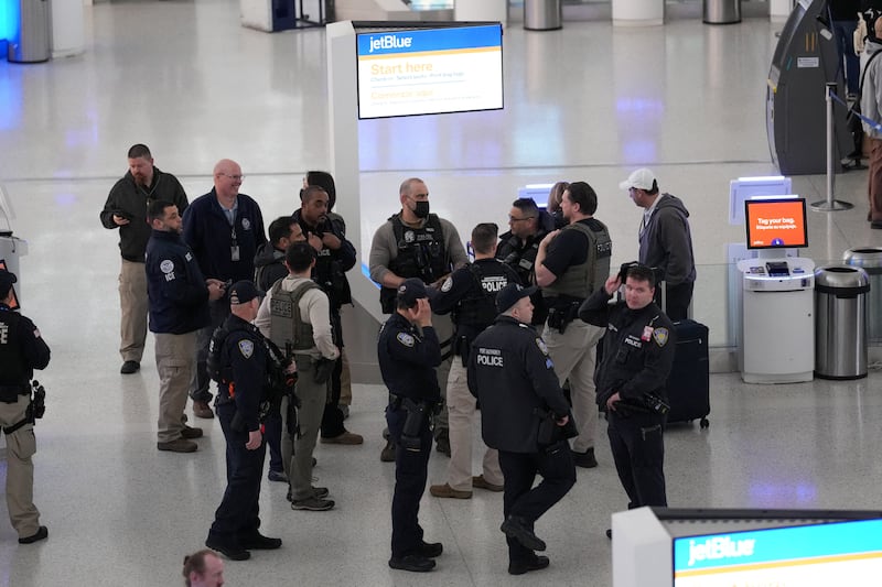 Immigration and Customs Enforcement (ICE) agents stand with other Law enforcement at John F. Kennedy International Airport, New York City, U.S. March 23, 2026. Hundreds of Immigration and Customs Enforcement agents were ordered to deploy to airports to help fill TSA staffing gaps across the country. REUTERS/Adam Gray