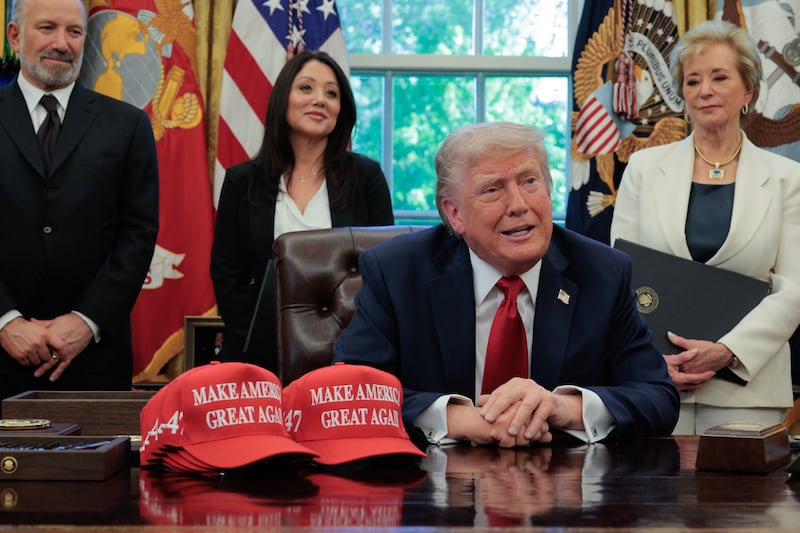 President Donald Trump speaks to the media as (L-R) Secretary of Commerce Howard Lutnick, Secretary of Labor Lori Chavez-DeRemer, and Secretary of Education Linda McMahon look on after signing executive orders in the Oval Office at the White House on April 23, 2025, in Washington, DC.