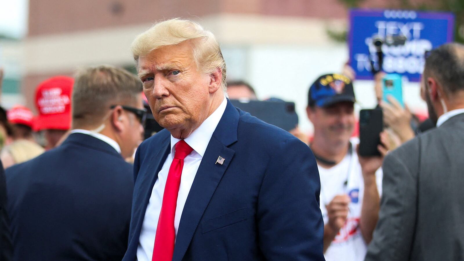 Former President Donald Trump leaves the opening of his campaign headquaters in Manchester, New Hampshire.