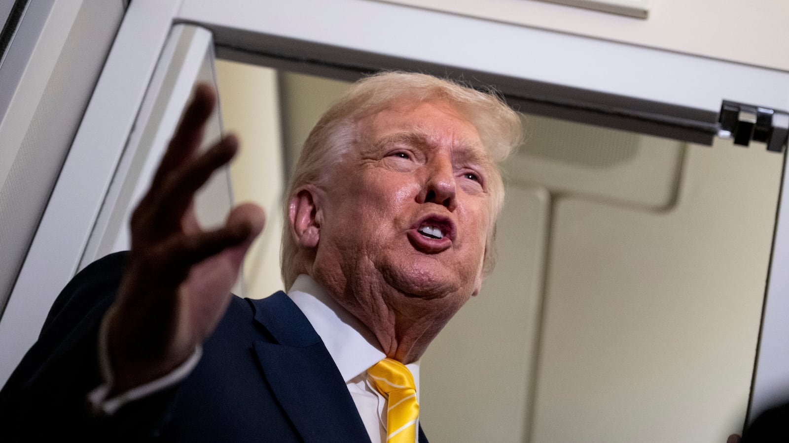 IN FLIGHT - NOVEMBER 14: U.S. President Donald Trump speaks to members of press aboard Air Force One on November 14, 2025 while in flight from Washington, DC to West Palm Beach International Airport. Trump is scheduled to spend the weekend at his Mar-A-Lago estate in Palm Beach, Florida. (Photo by Roberto Schmidt/Getty Images)