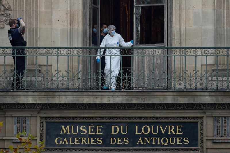 A French Forensics Officer examines the cut window and balcony of a gallery at the Louvre Museum on October 19, 2025 in Paris, France. France's Culture Minister, Rachida Dati, announced the closure of the world-famous art museum on X due to the robbery taking place just after the Louvre opened to the public. It is being reported that millions of pound with of historic jewellery belonging to Napoleon and Empress Josephine has been stolen (Photo by