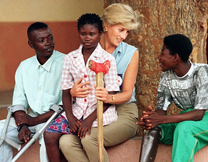 Diana, Princess of Wales, on a four day visit to Angola talks to disabled former government soldiers at an orthopaedic centre outside Luanda , January 14 . It was one of her first face-to-face contacts with victims of landmines. Angola is one of the world's most heavily-mined countries.