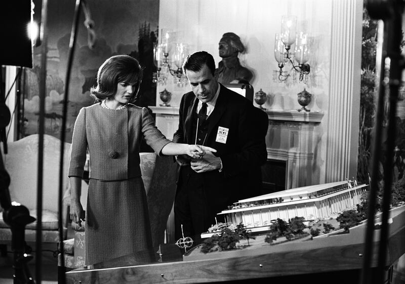 NBC NEWS - NATIONAL CULTURE CENTER WITH JACQUELINE KENNEDY -- Air Date 11/11/1962 -- Pictured: (l-r) First Lady Jacqueline Kennedy discussing plans for the new National Culture Center, unknown crew member (later renamed The Kennedy Center) in the Diplomatic Reception Room of the White House on November 5, 1962 -- Photo by: Art Selby/NBC NewsWire