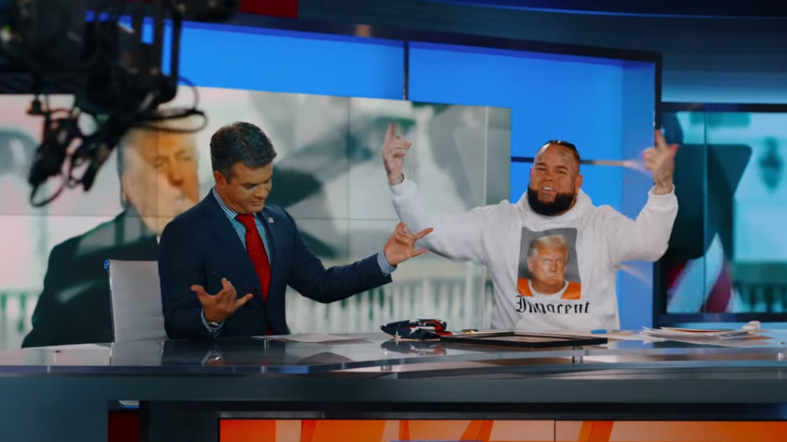 MAGA rapper Forgiato Blow and OAN host Dan Ball dance for the camera.