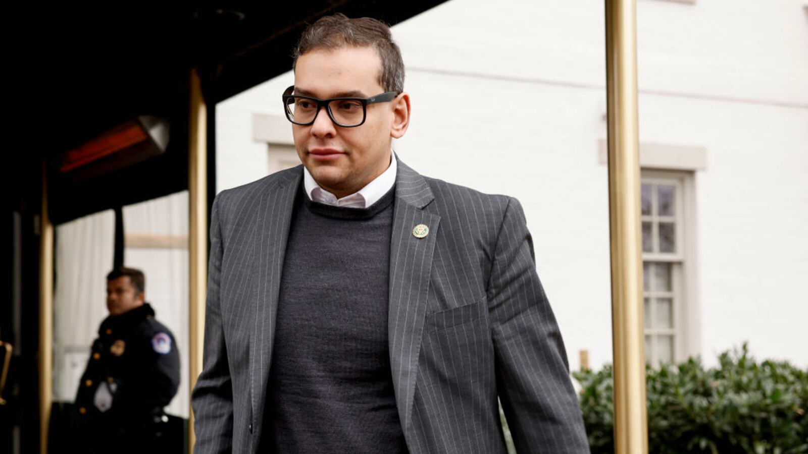 New York Rep. George Santos exits a GOP caucus meeting on Capitol Hill.