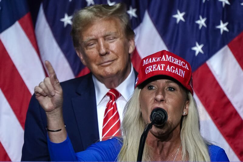 Marjorie Taylor Greene speaks alongside Donald Trump at a campaign event in Rome, Georgia.