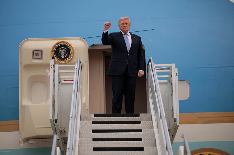 U.S. President Donald Trump gestures as he departs Beijing Capital International Airport aboard Air Force One, in Beijing, China, May 15, 2026.