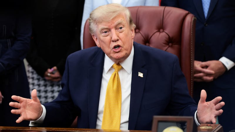 U.S. President Donald Trump answers questions from the media after signing an executive order establishing the President's Military Spouse Commission to be chaired by Jennifer Rauchet, wife of Secretary of Defense Pete Hegseth, in the Oval Office at the White House in Washington, D.C., U.S., August 3, 2026.