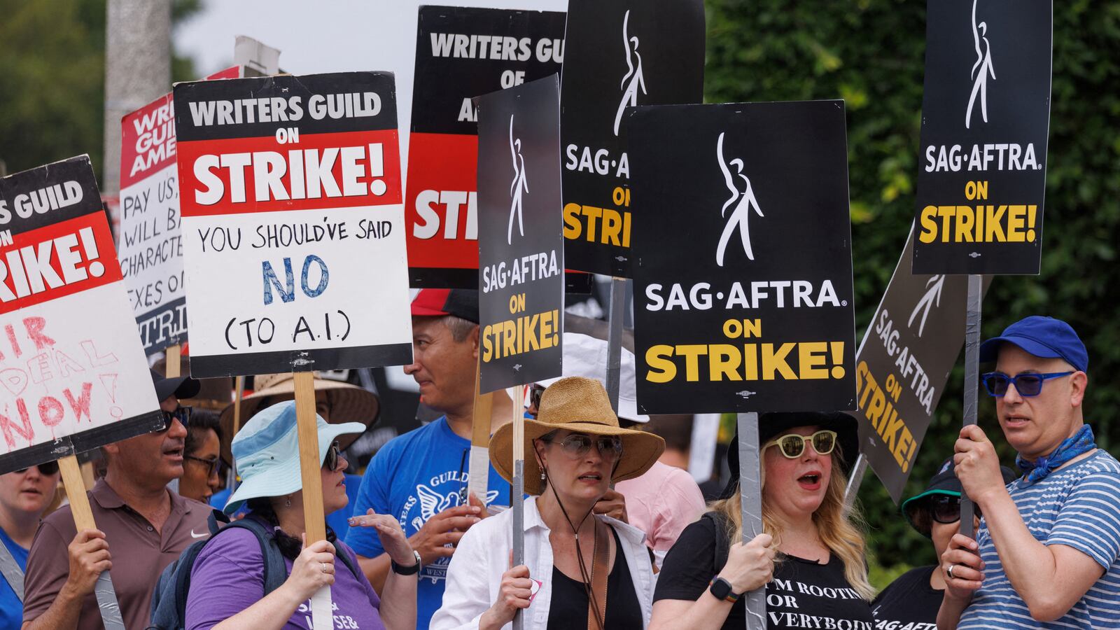 SAG-AFTRA actors and Writers Guild of America (WGA) writers walk a picket line in Los Angeles, California. Universal Pictures has been accused of trimming trees that shaded SAG-AFTRA and WGA strikers from the sweltering heat.