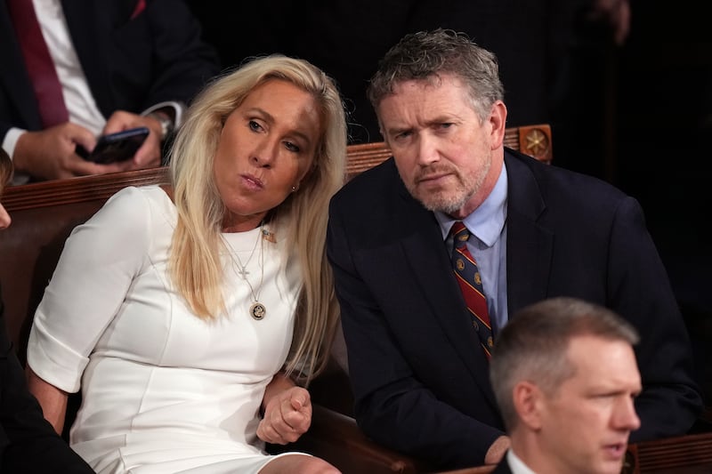 WASHINGTON, DC - JANUARY 03: U.S. Rep. Marjorie Taylor Greene (R-GA) (L) talks with Rep. Thomas Massie (R-KY) as the House votes for a Speaker of the House on the first day of the 119th Congress in the House Chamber of the U.S. Capitol Building on January 03, 2025 in Washington, DC. Rep. Mike Johnson (R-LA) is working to retain the Speakership in the face of opposition within his own party as the 119th Congress holds its first session to vote for a new Speaker of the House.
