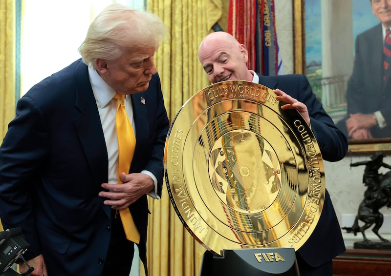 WASHINGTON, DC - MARCH 07: U.S. President Donald Trump and President of Fédération Internationale de Football Association (FIFA) Gianni Infantino unveil the 2025 Club World Cup trophy in the Oval Office at the White House on March 07, 2025 in Washington, DC. President Trump signed an executive order establishing a White House Task Force for the 2026 World Cup.  (Photo by Anna Moneymaker/Getty Images)
