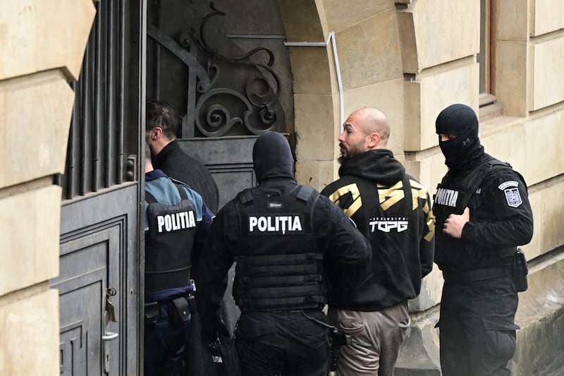 British-US former professional kickboxer and controversial influencer Andrew Tate (2ndR) and his brother Tristan Tate (2ndL, hidden) are led by police officers into the Court of Appeal building in Bucharest, Romania on March 12, 2024.