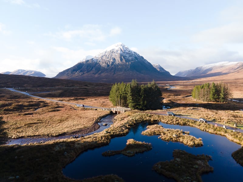 GLENCOE HIGHLANDS, SCOTLAND - JANUARY 05: An aerial view of puddle of water in front of snow-covered mountain at Glencoe Highlands, Scotland, in the northwest region of the United Kingdom on January 05, 2024. (Photo by Ahmet Fevzi Arican/Anadolu via Getty Images)