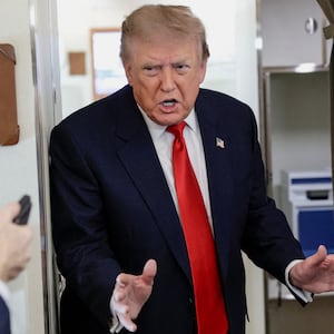 U.S. President Donald Trump speaks to reporters aboard Air Force One en route to Michigan, U.S., July 27, 2026. REUTERS/Evan Vucci