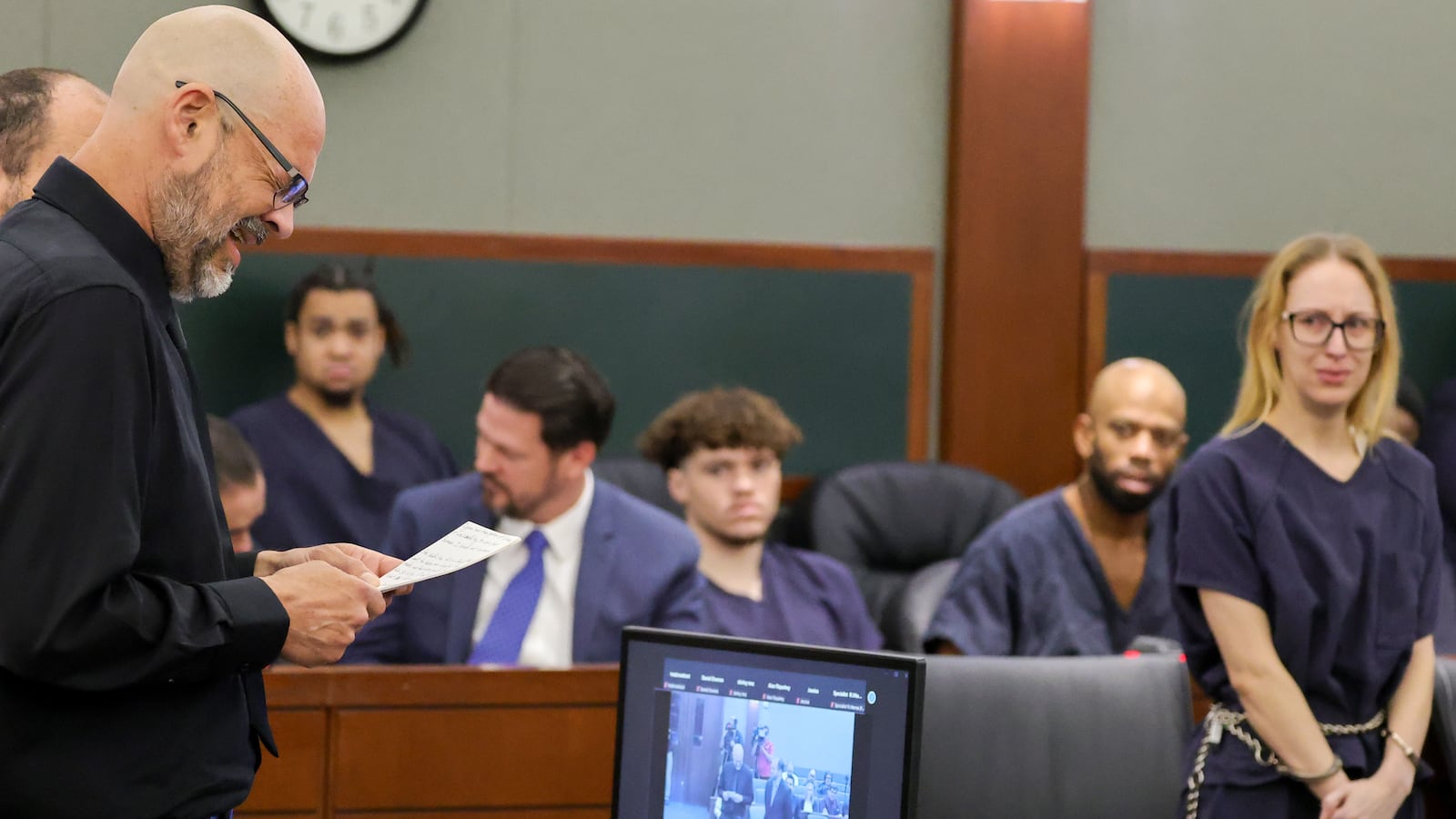 Aaron Goodwin (L) reads a victim impact statement as Victoria Goodwin (R) listens in Clark County District Court.