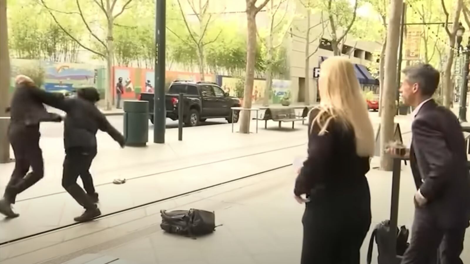 San Jose Mayor Matt Mahan, far right, was speaking on camera when a man, who police have identified as 35-year-old Wesley Pollard, approached his security detail from behind.