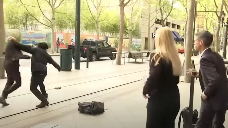 San Jose Mayor Matt Mahan, far right, was speaking on camera when a man, who police have identified as 35-year-old Wesley Pollard, approached his security detail from behind.